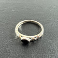Dainty 925 sterling silver ring size 6.5 featuring a bezel-set black stone and an openwork cutout diamond pattern band.