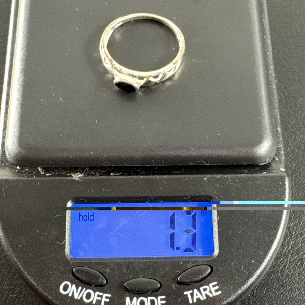 Dainty 925 sterling silver ring size 6.5 featuring a bezel-set black stone and an openwork cutout diamond pattern band.