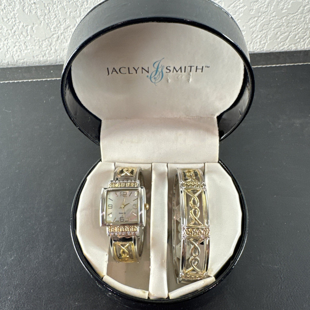 Jaclyn Smith gold tone women's watch and bracelet set featuring a black square case, white dial, and original box.