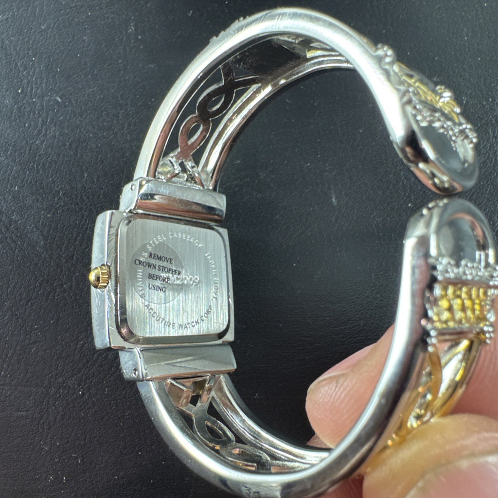 Jaclyn Smith gold tone women's watch and bracelet set featuring a black square case, white dial, and original box.