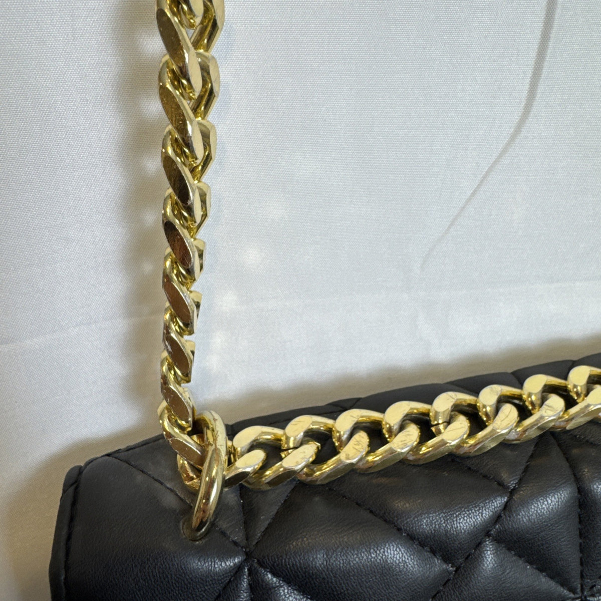 Like Dreams black quilted vegan leather crossbody bag with gold chain accent