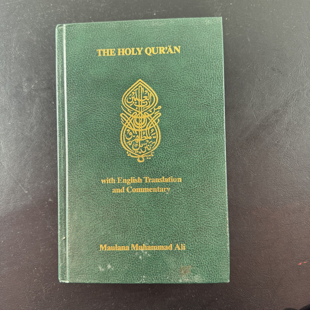 Green gold-gilt hardcover of The Holy Qur'an with English translation and commentary by Maulana Muhammad Ali.