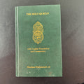 Green gold-gilt hardcover of The Holy Qur'an with English translation and commentary by Maulana Muhammad Ali.