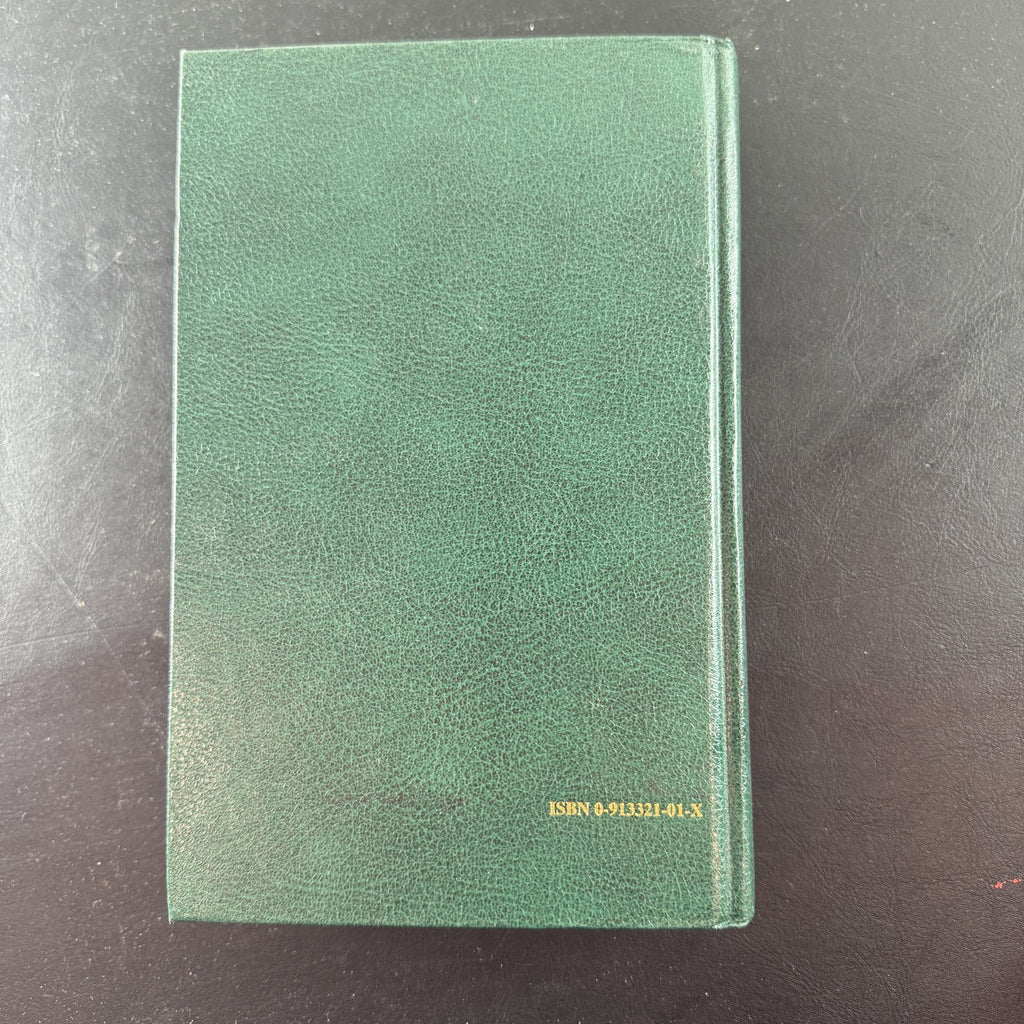 Green gold-gilt hardcover of The Holy Qur'an with English translation and commentary by Maulana Muhammad Ali.