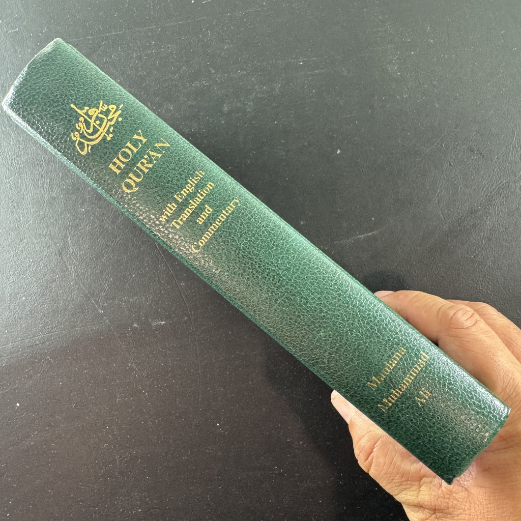 Green gold-gilt hardcover of The Holy Qur'an with English translation and commentary by Maulana Muhammad Ali.