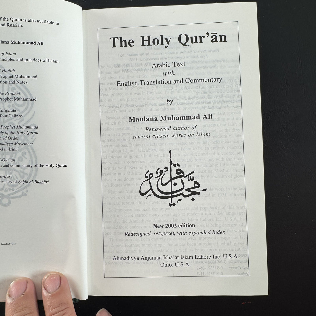 Green gold-gilt hardcover of The Holy Qur'an with English translation and commentary by Maulana Muhammad Ali.