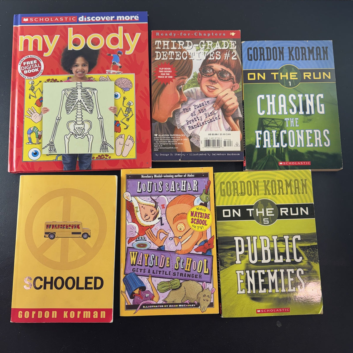 Curated lot of 6 kids adventure and humor books including Gordon Korman and Louis Sachar titles