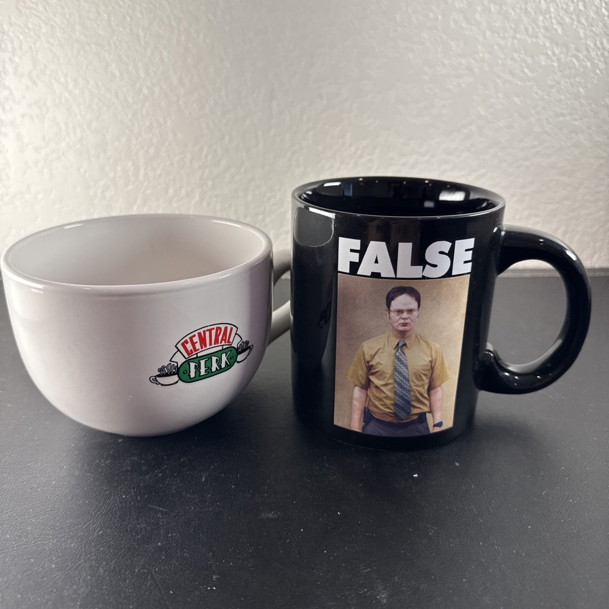 Set of 2 television show coffee mugs featuring Friends Central Perk jumbo mug and The Office Dwight Schrute black mug.