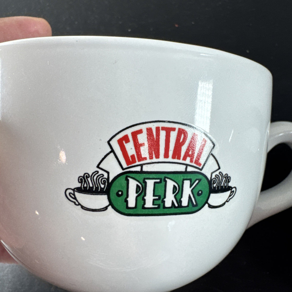 Set of 2 television show coffee mugs featuring Friends Central Perk jumbo mug and The Office Dwight Schrute black mug.