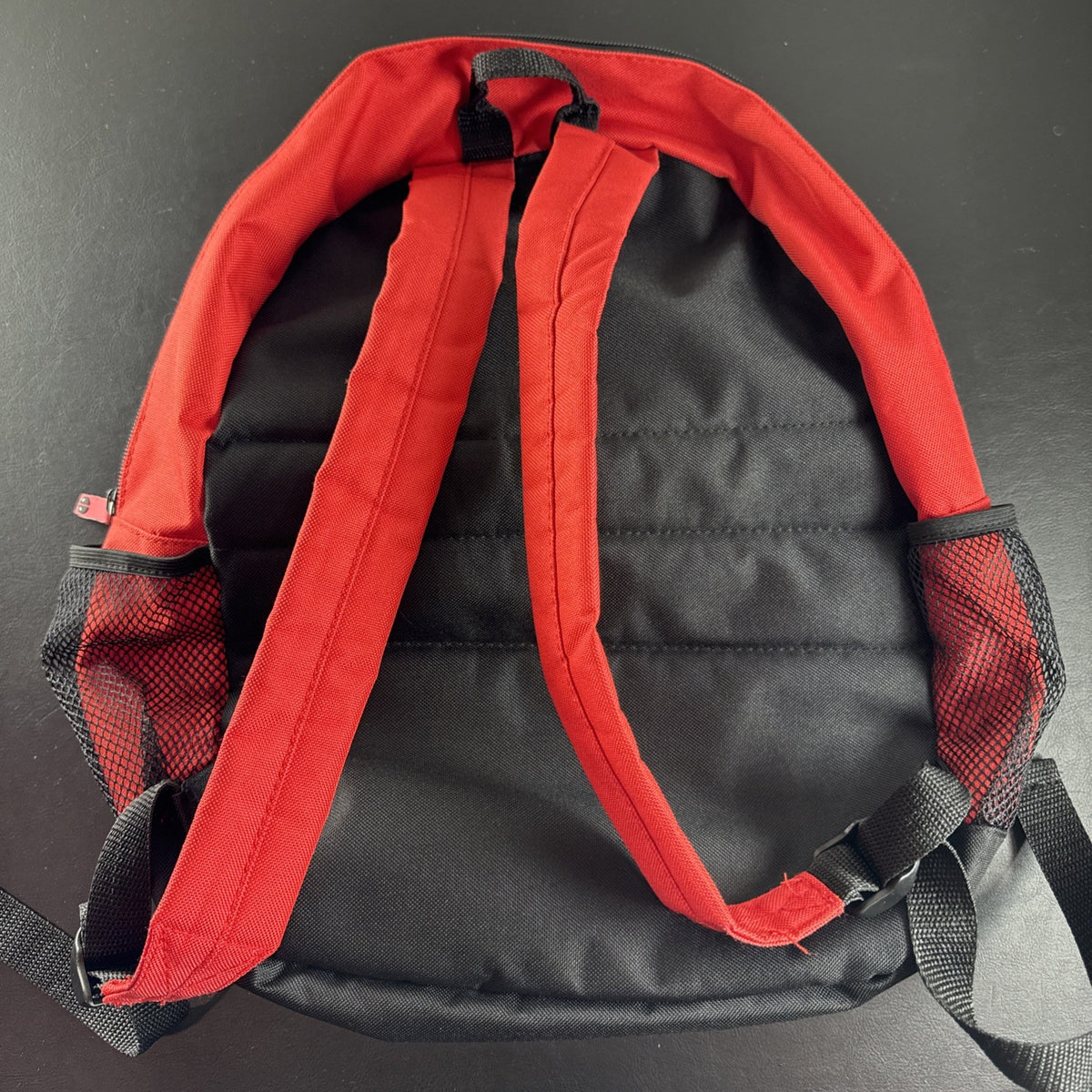Official Marvel Deadpool red and black character backpack featuring the iconic eye mask design.