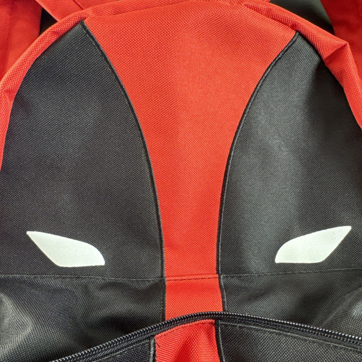 Official Marvel Deadpool red and black character backpack featuring the iconic eye mask design.