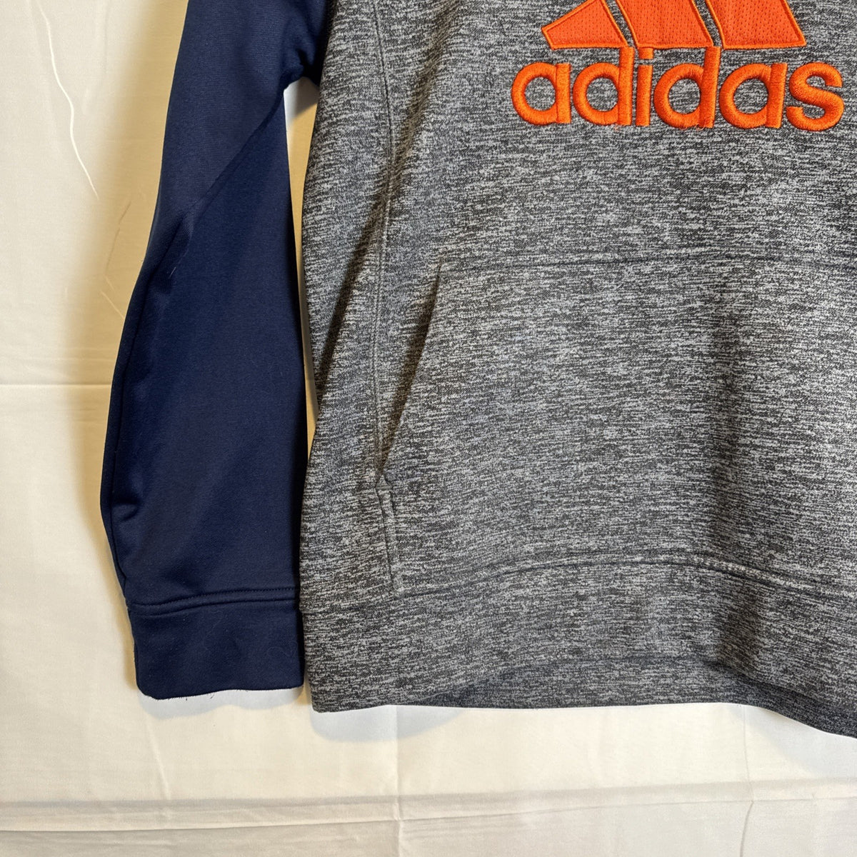 adidas youth size Large gray fleece pullover hoodie with dark blue and orange accents and stitched logo