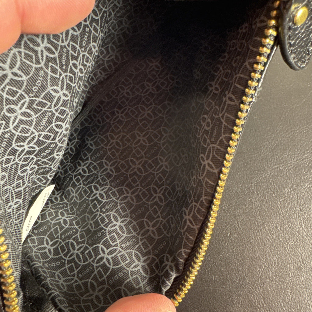 LODIS black pebbled leather wristlet clutch and matching card wallet set with gold-tone hardware.