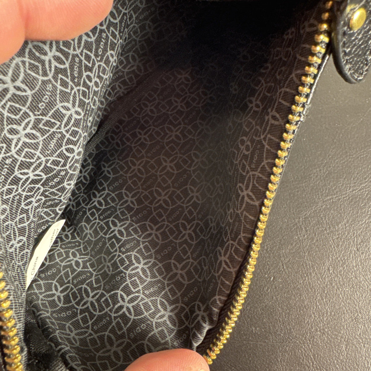 LODIS black pebbled leather wristlet clutch and matching card wallet set with gold-tone hardware.