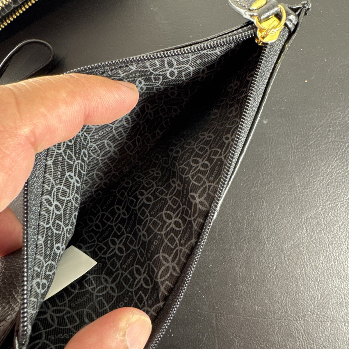 LODIS black pebbled leather wristlet clutch and matching card wallet set with gold-tone hardware.