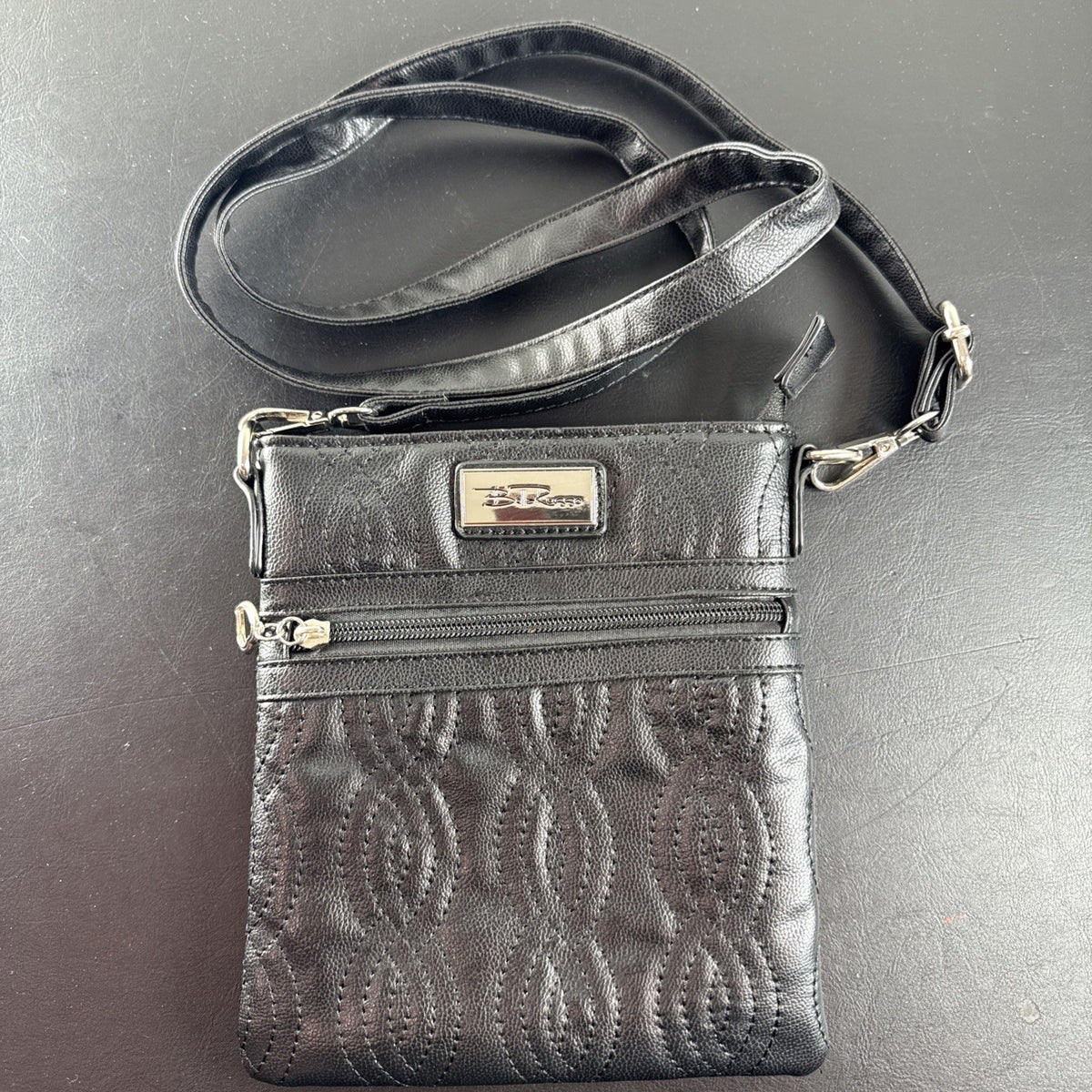 Bella Russo black quilted faux leather crossbody bag with silver-tone heart zipper pull.