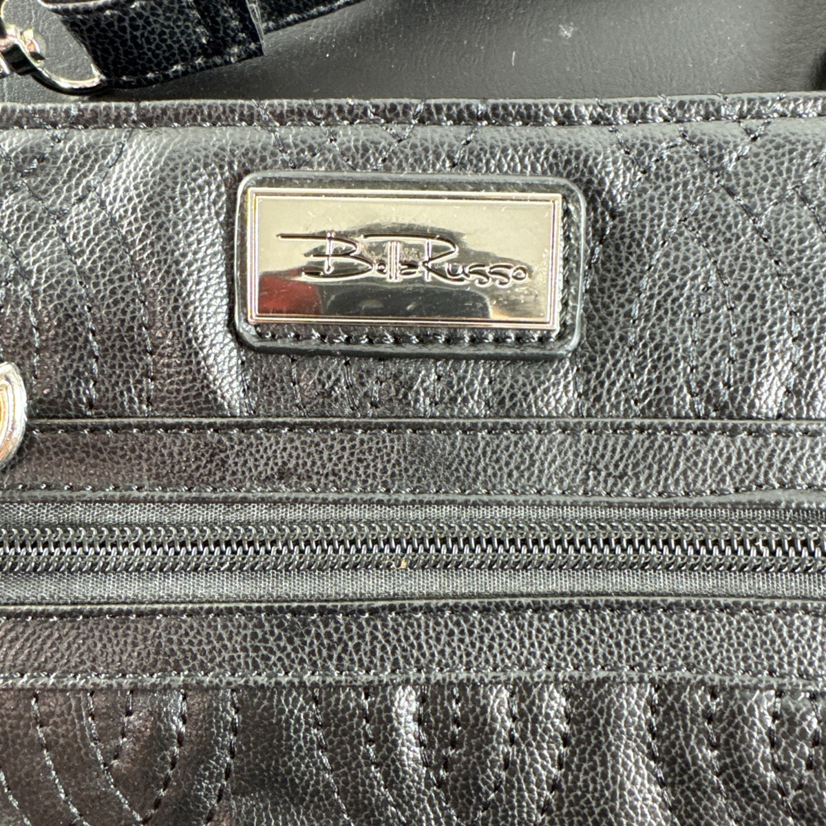 Bella Russo black quilted faux leather crossbody bag with silver-tone heart zipper pull.