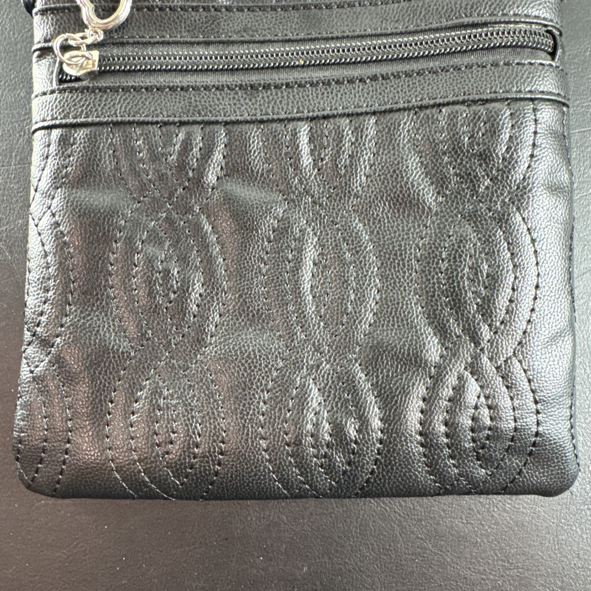 Bella Russo black quilted faux leather crossbody bag with silver-tone heart zipper pull.