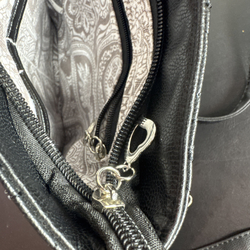 Bella Russo black quilted faux leather crossbody bag with silver-tone heart zipper pull.