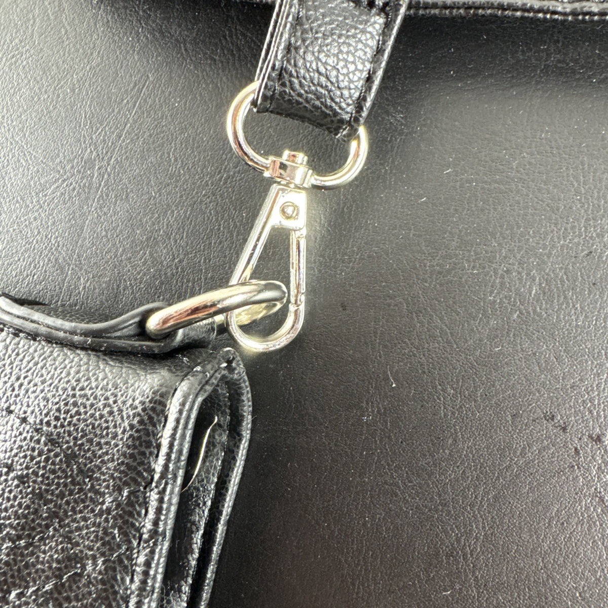 Bella Russo black quilted faux leather crossbody bag with silver-tone heart zipper pull.