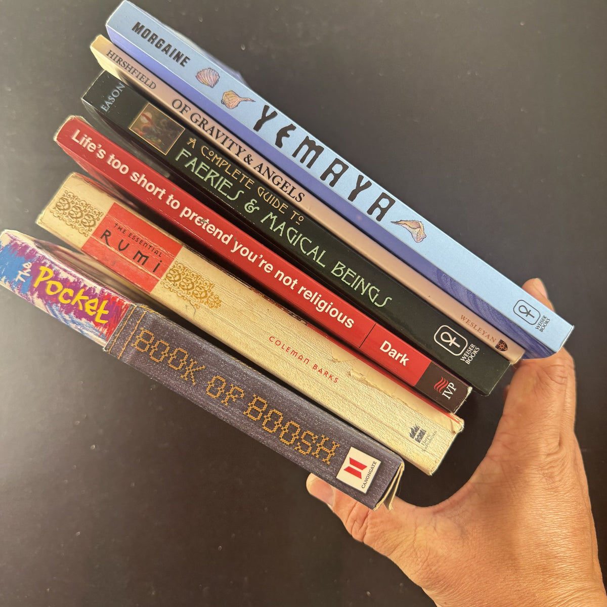 Set of 6 paperback books on spirituality, folklore, and poetry including The Essential Rumi and Yemaya.