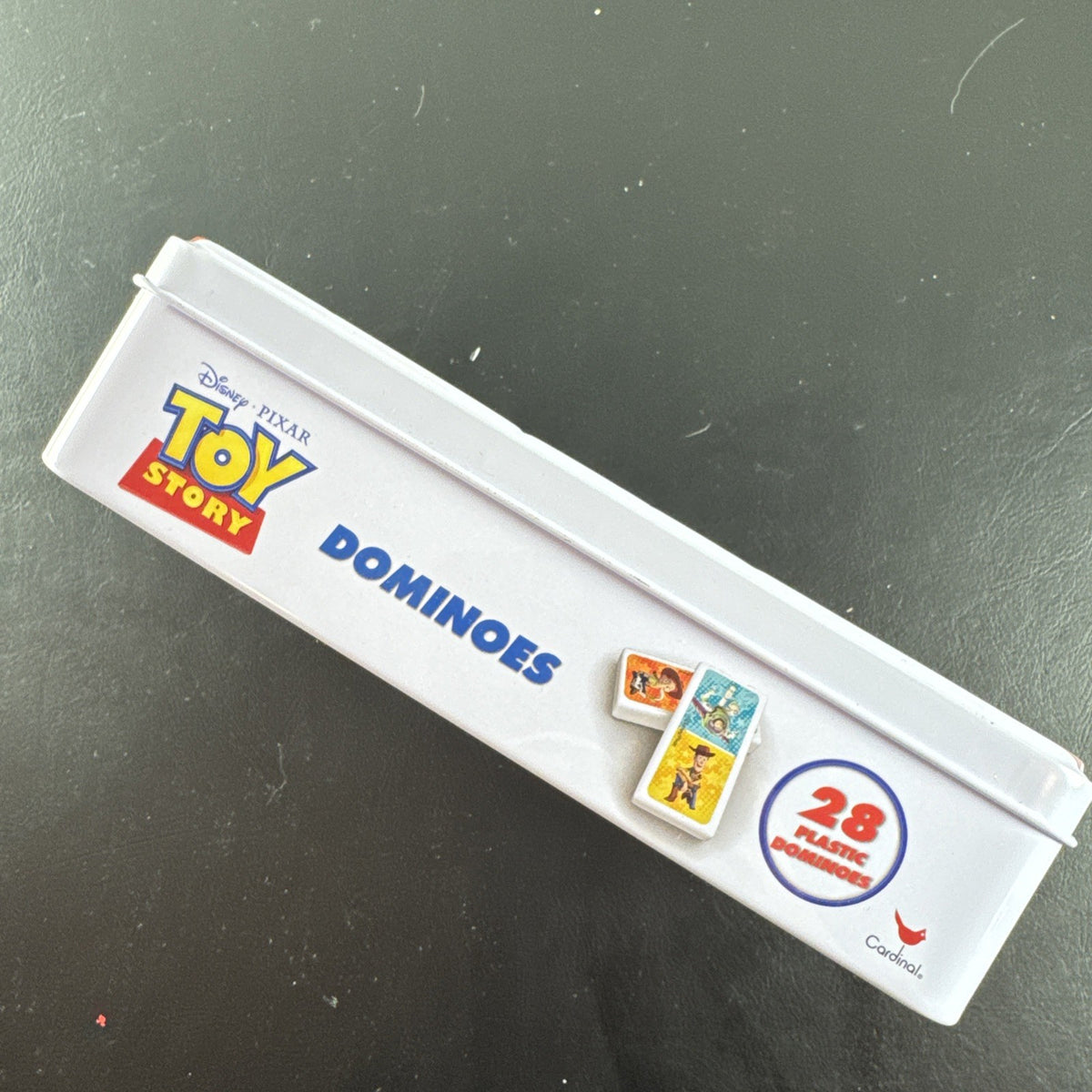 Complete 2006 Disney Pixar Toy Story dominoes game set featuring movie characters.