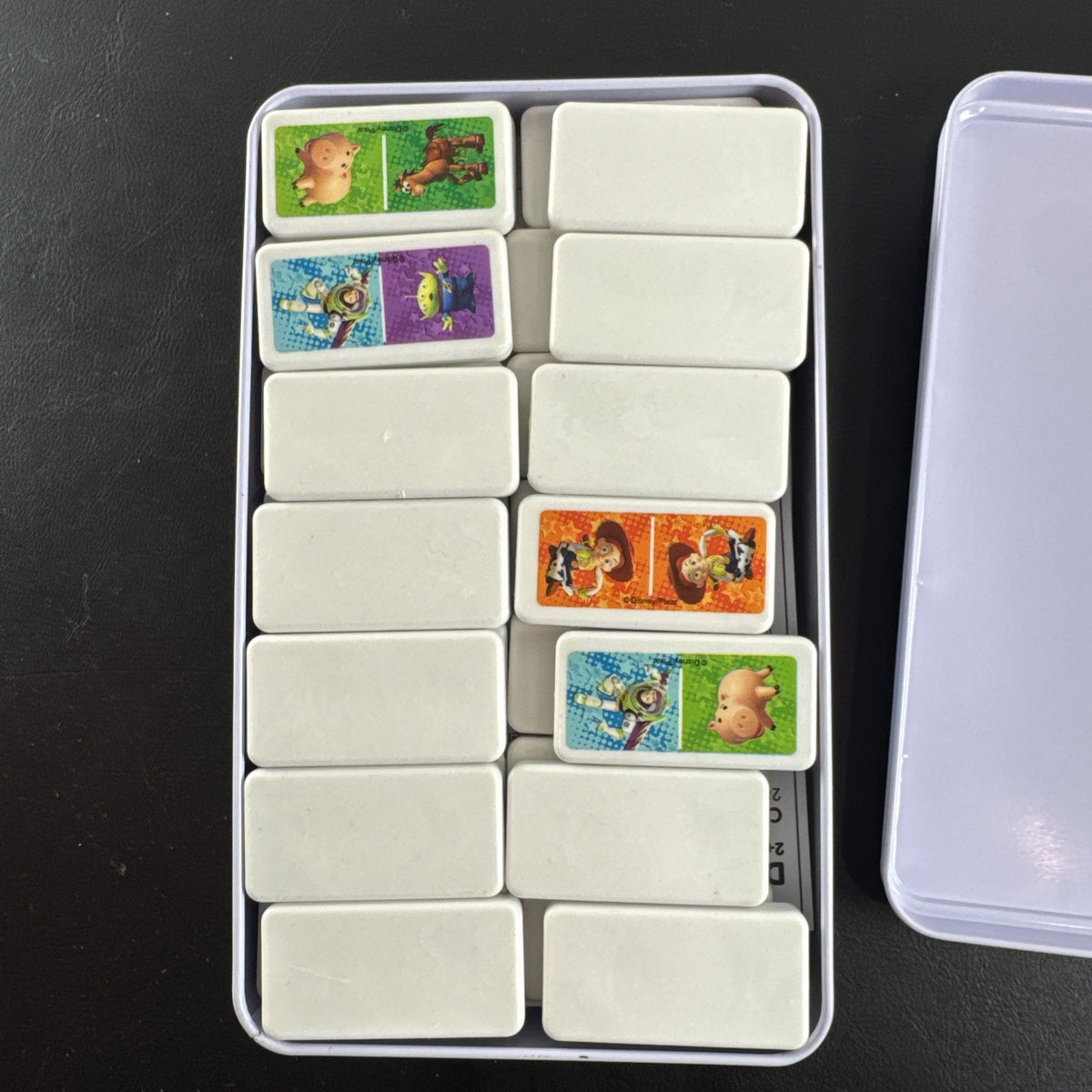 Complete 2006 Disney Pixar Toy Story dominoes game set featuring movie characters.