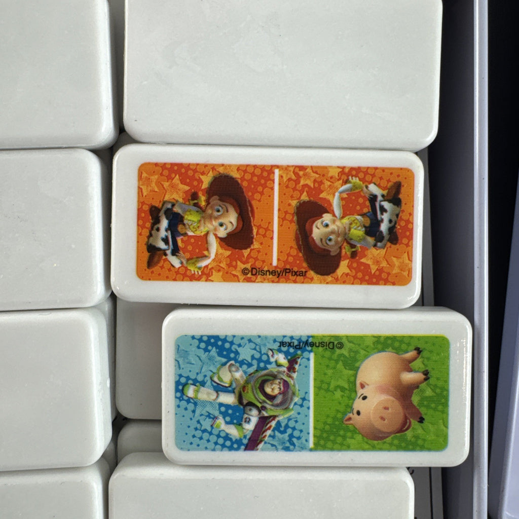Complete 2006 Disney Pixar Toy Story dominoes game set featuring movie characters.