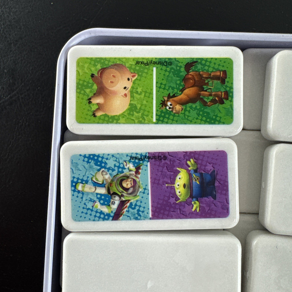 Complete 2006 Disney Pixar Toy Story dominoes game set featuring movie characters.