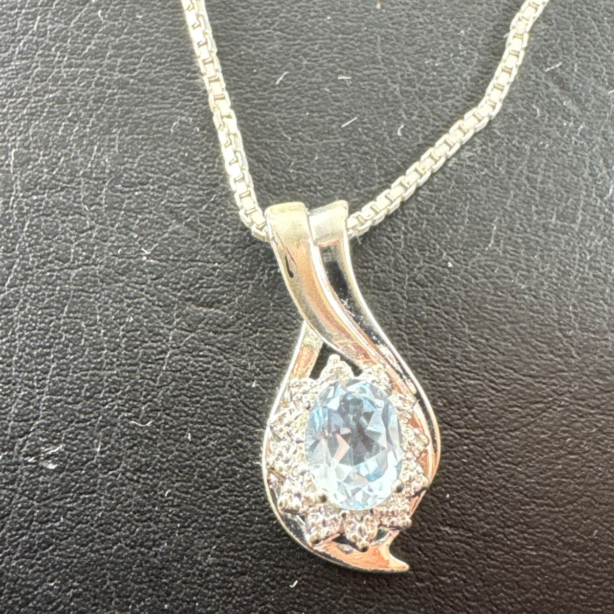 Solid 925 sterling silver teardrop swirl pendant with a light blue oval stone on an Italian box chain.