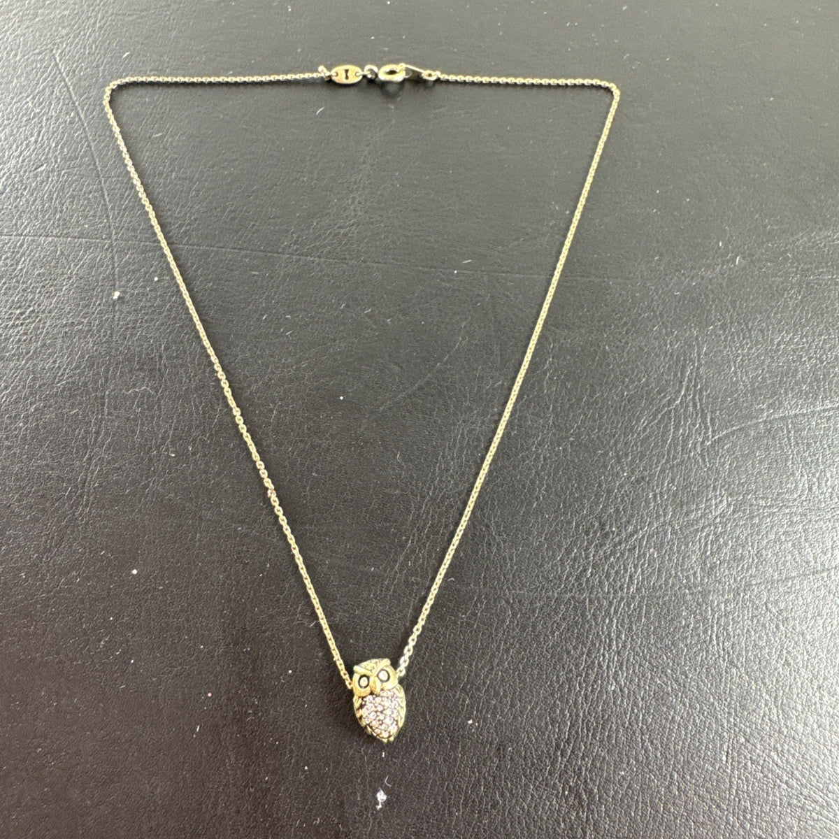 Fossil owl pendant necklace featuring a clear pavé rhinestone belly and signature mini key charm on a display card.