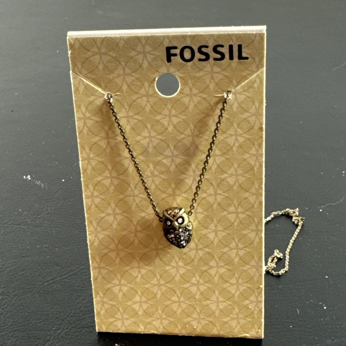 Fossil owl pendant necklace featuring a clear pavé rhinestone belly and signature mini key charm on a display card.