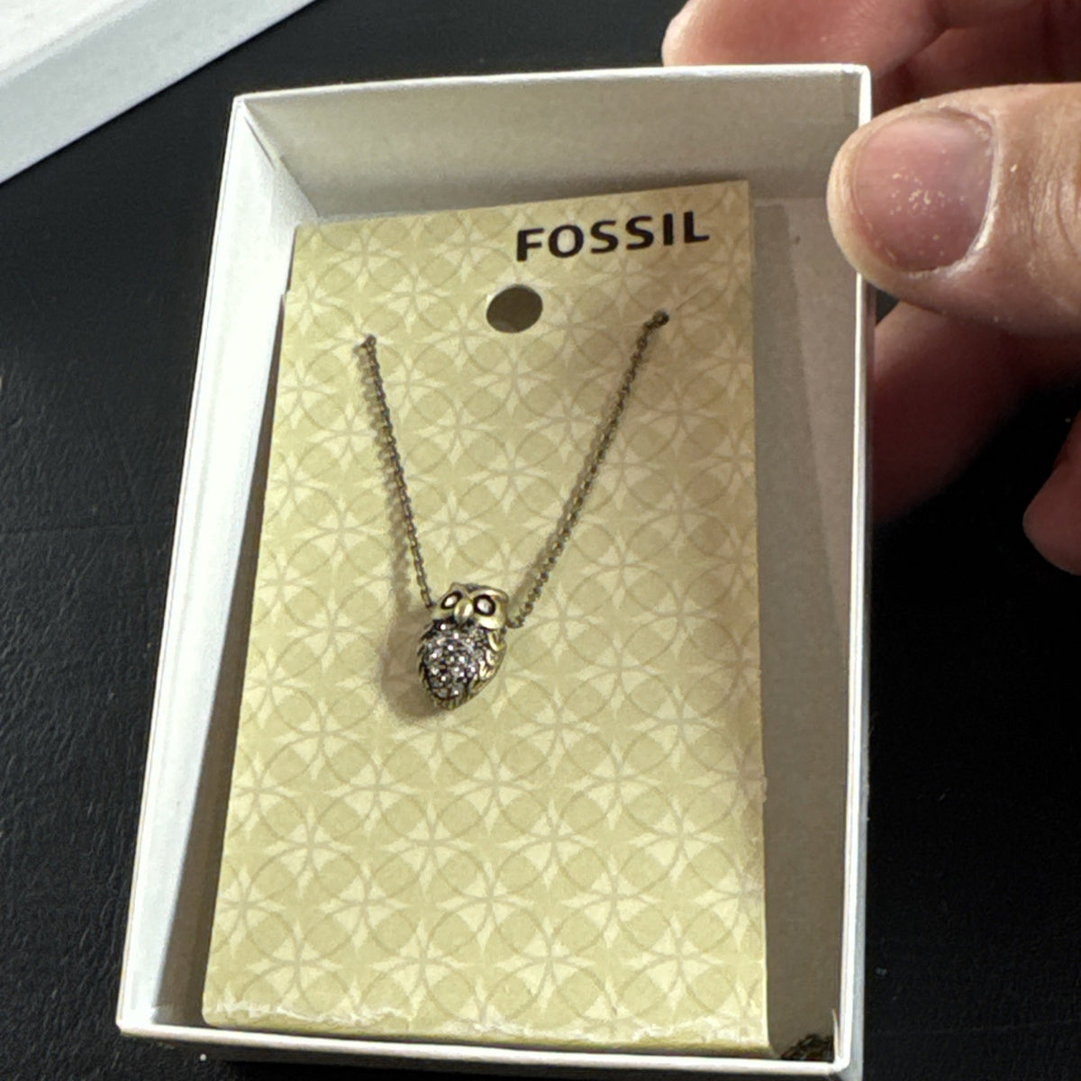Fossil owl pendant necklace featuring a clear pavé rhinestone belly and signature mini key charm on a display card.
