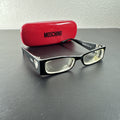 Vintage Moschino MO01701 black acetate eyeglass frames with rhinestone heart cutouts on temple arms.