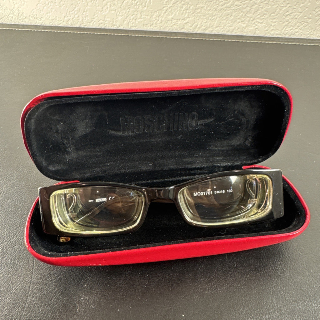 Vintage Moschino MO01701 black acetate eyeglass frames with rhinestone heart cutouts on temple arms.