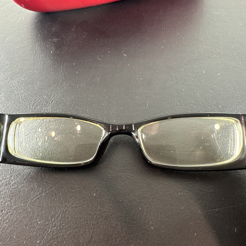Vintage Moschino MO01701 black acetate eyeglass frames with rhinestone heart cutouts on temple arms.