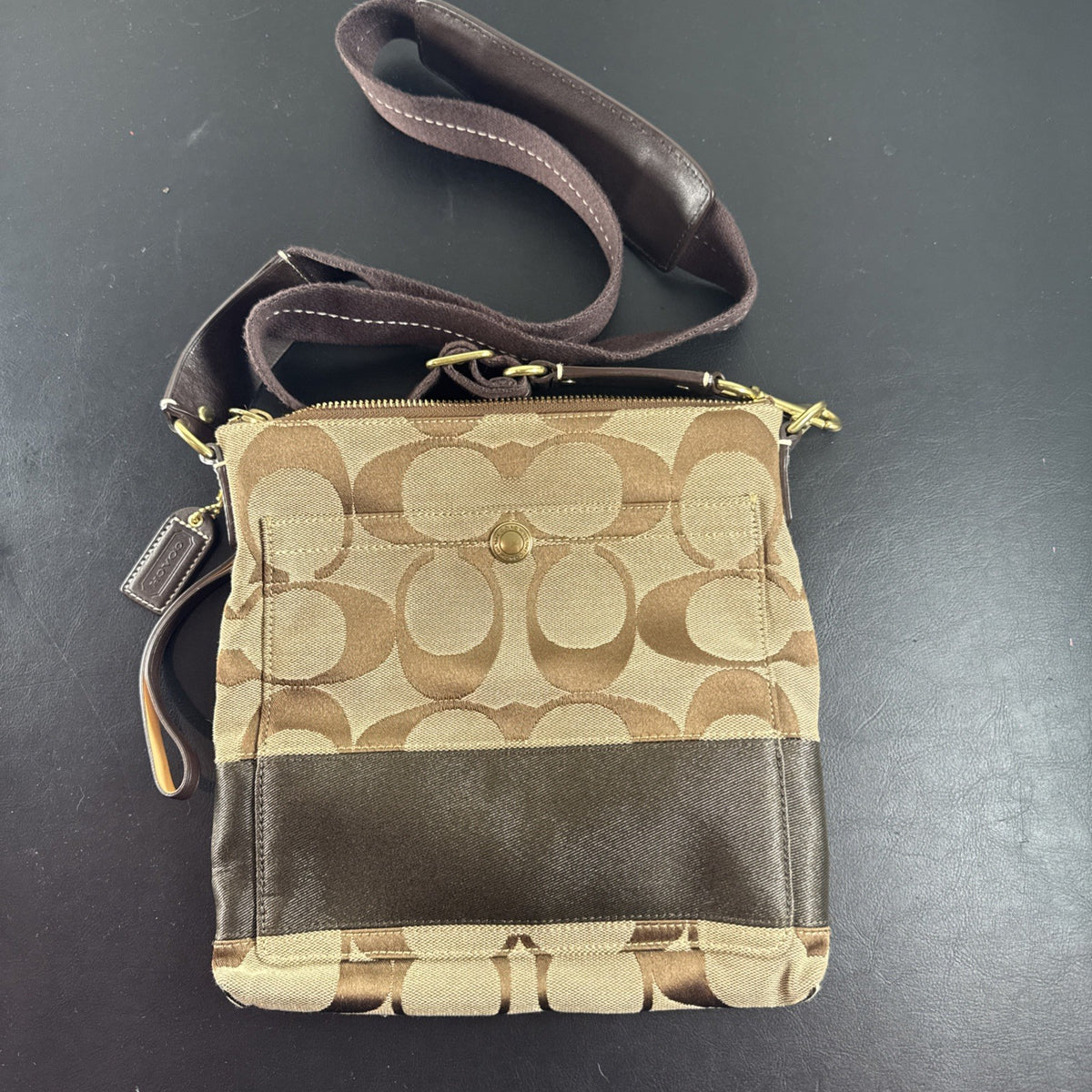 Coach khaki and brown signature jacquard canvas file crossbody bag with leather trim and gold-tone hardware.