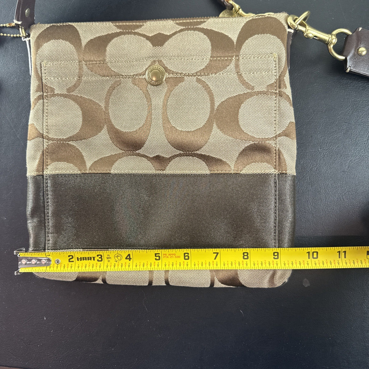 Coach khaki and brown signature jacquard canvas file crossbody bag with leather trim and gold-tone hardware.