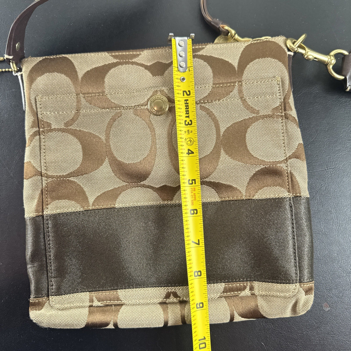 Coach khaki and brown signature jacquard canvas file crossbody bag with leather trim and gold-tone hardware.
