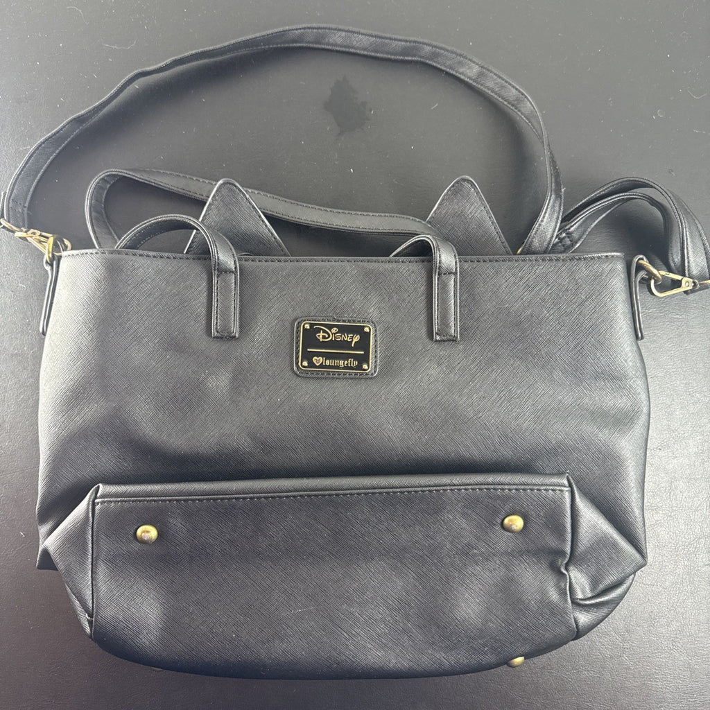 Loungefly Disney Hocus Pocus Thackery Binx black faux leather tote bag showing die-cut cat ears and green eyes.