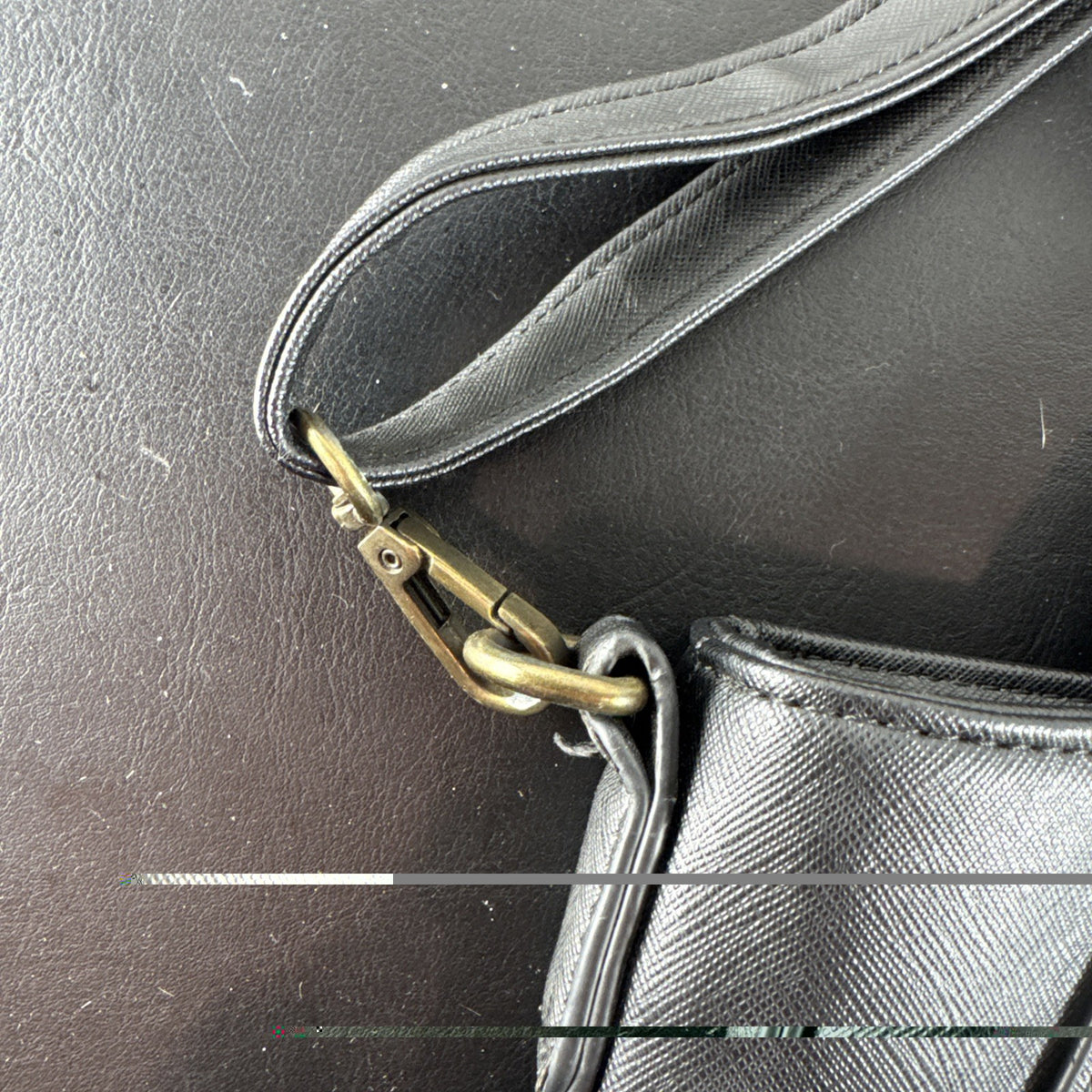 Loungefly Disney Hocus Pocus Thackery Binx black faux leather tote bag showing die-cut cat ears and green eyes.