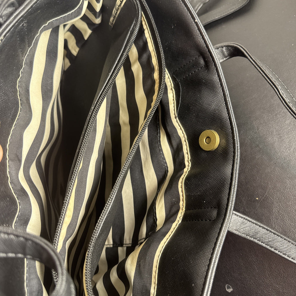 Loungefly Disney Hocus Pocus Thackery Binx black faux leather tote bag showing die-cut cat ears and green eyes.