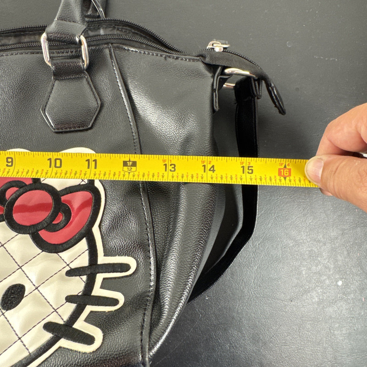 Hello Kitty black faux leather satchel bag with quilted character applique and silver logo charm
