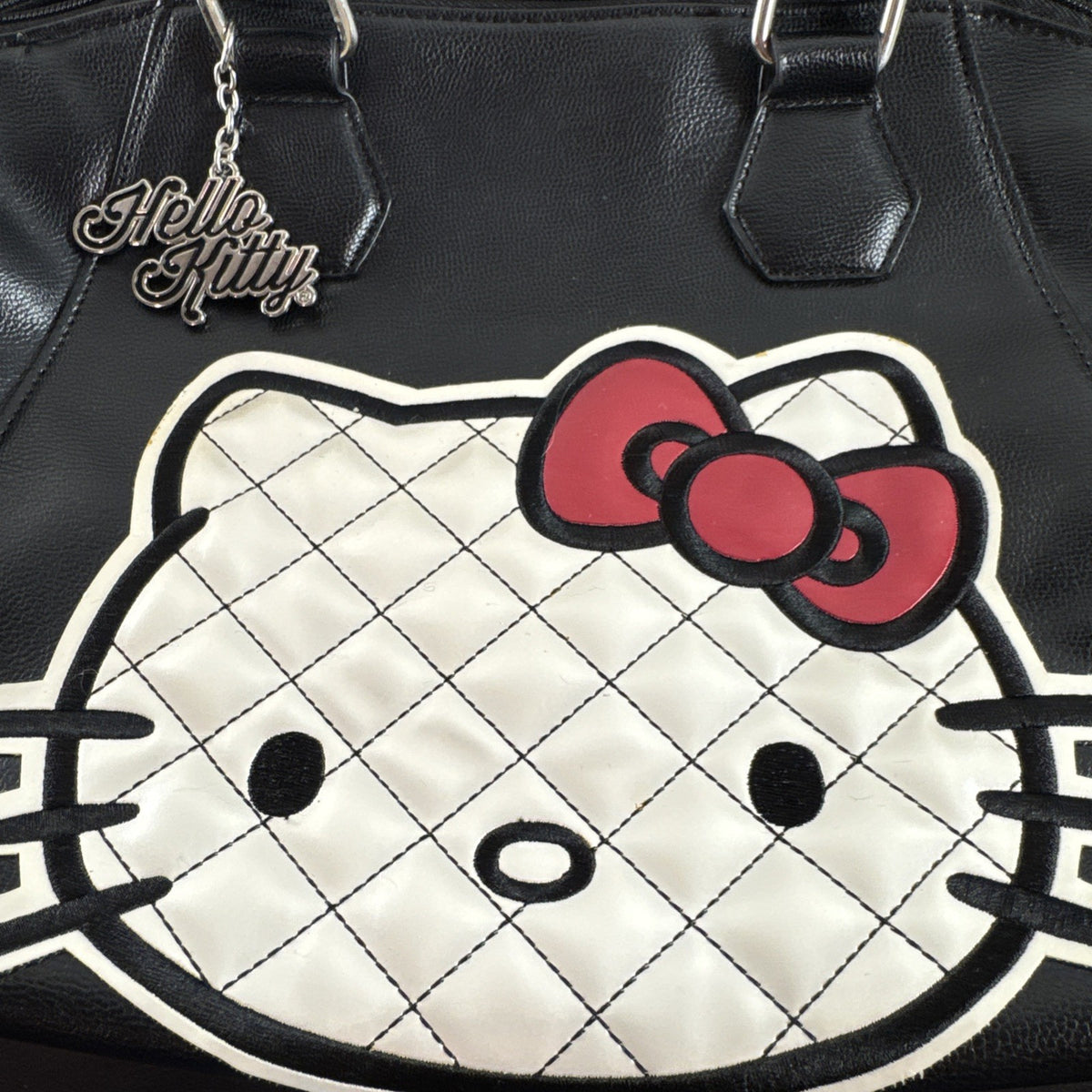 Hello Kitty black faux leather satchel bag with quilted character applique and silver logo charm