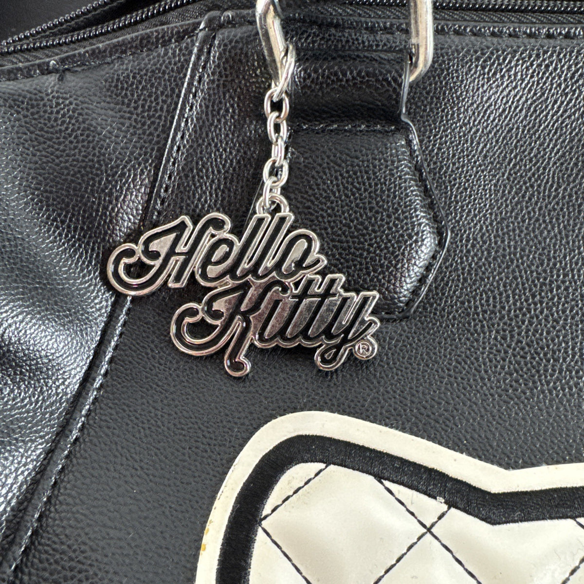 Hello Kitty black faux leather satchel bag with quilted character applique and silver logo charm