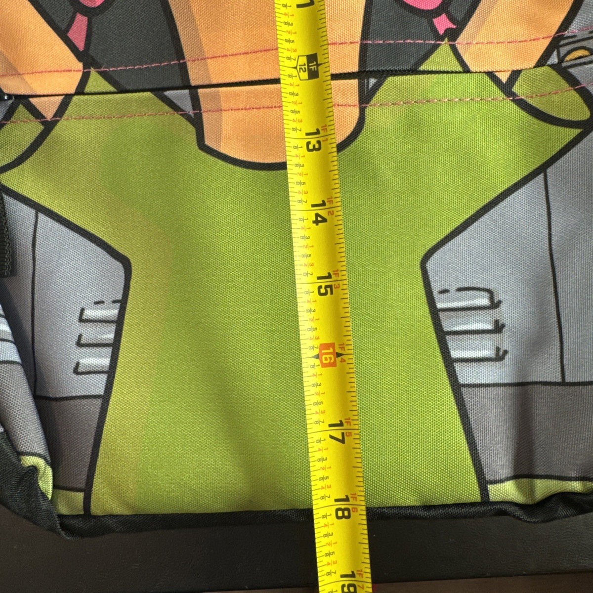 Bob's Burgers Louise Belcher backpack in pink and green featuring a graphic of Louise wearing bunny ears.