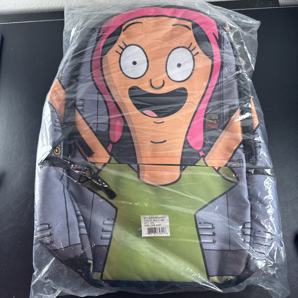 Bob's Burgers Louise Belcher backpack in pink and green featuring a graphic of Louise wearing bunny ears.
