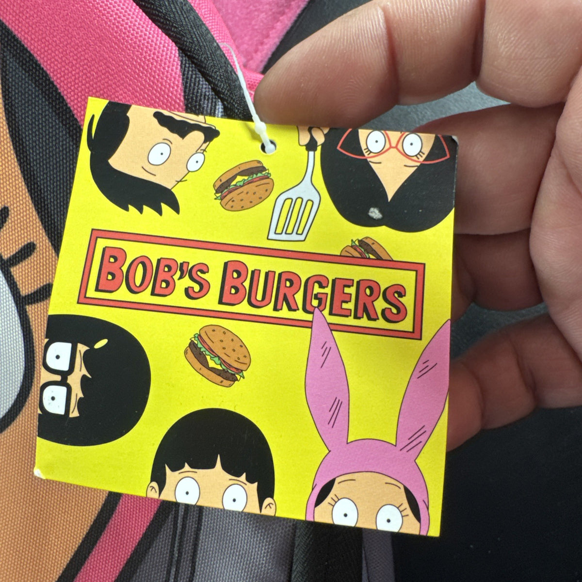 Bob's Burgers Louise Belcher backpack in pink and green featuring a graphic of Louise wearing bunny ears.