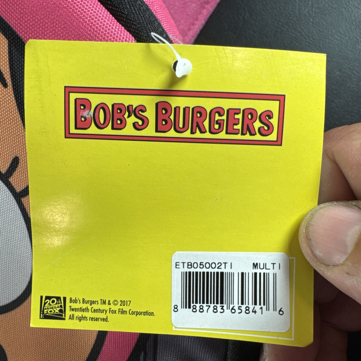 Bob's Burgers Louise Belcher backpack in pink and green featuring a graphic of Louise wearing bunny ears.