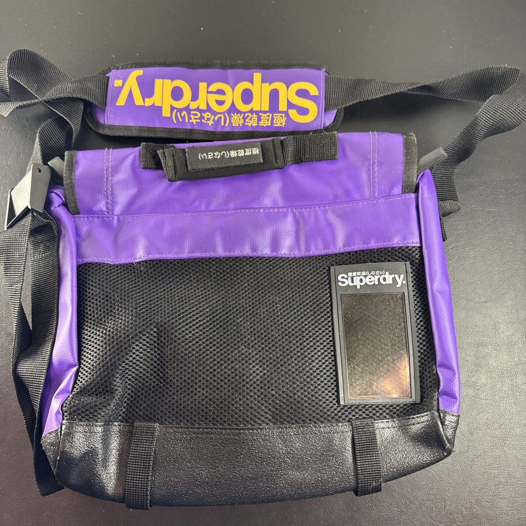Purple and yellow Superdry tarp messenger bag with bold logo spellout and padded shoulder strap.